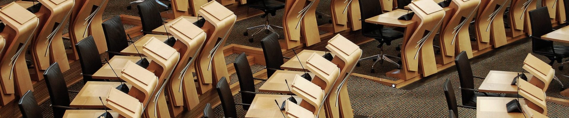 A horizontal shot of the desks inside of the Scottish parliament building